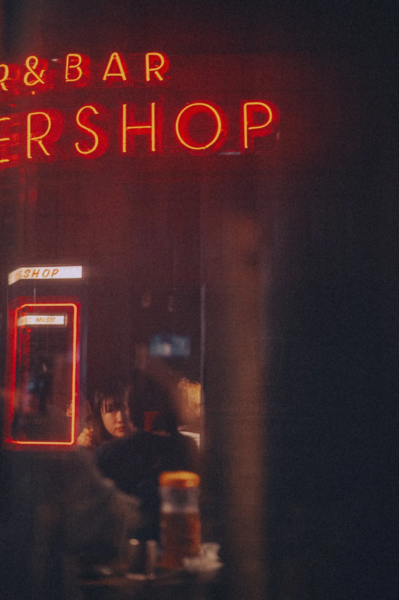 A woman through a restaurant window in Seoul, South Korea.