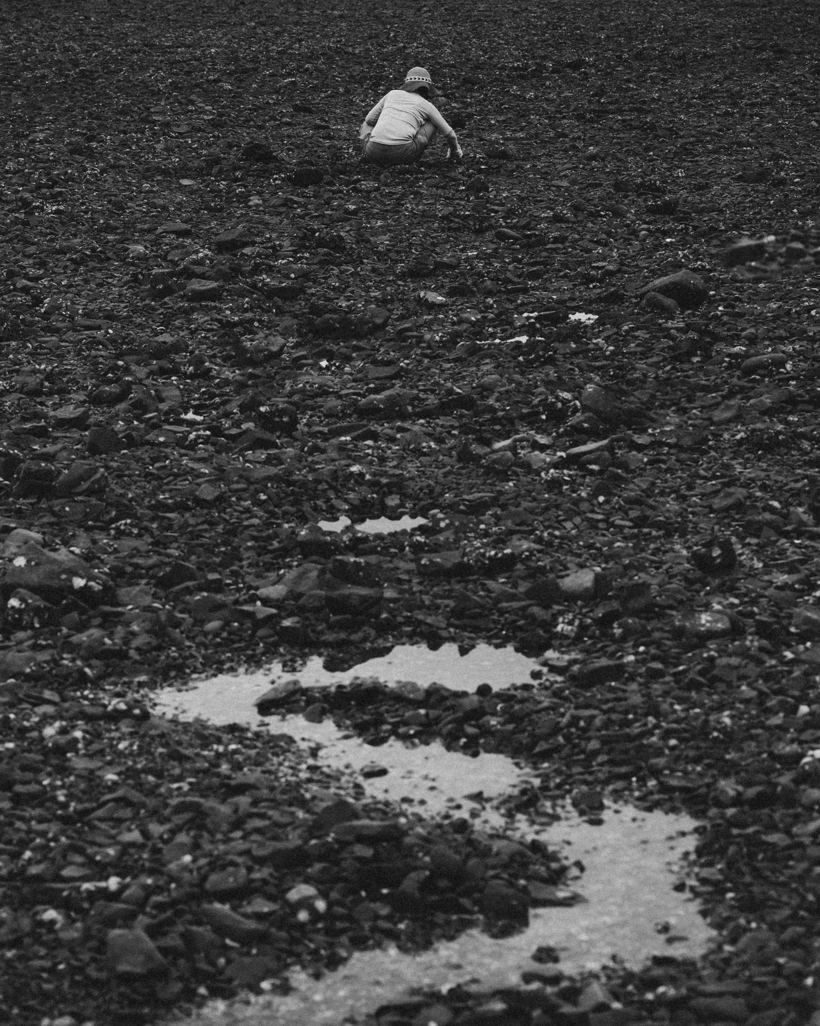 A woman on a shore or rocks and stones in Seoul, South Korea.