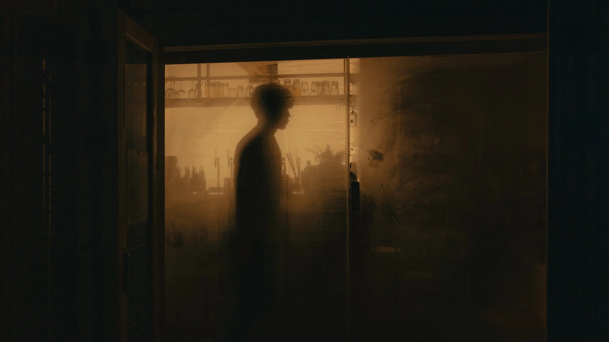 A window with condensation with a man in the middle in Seoul, South Korea.