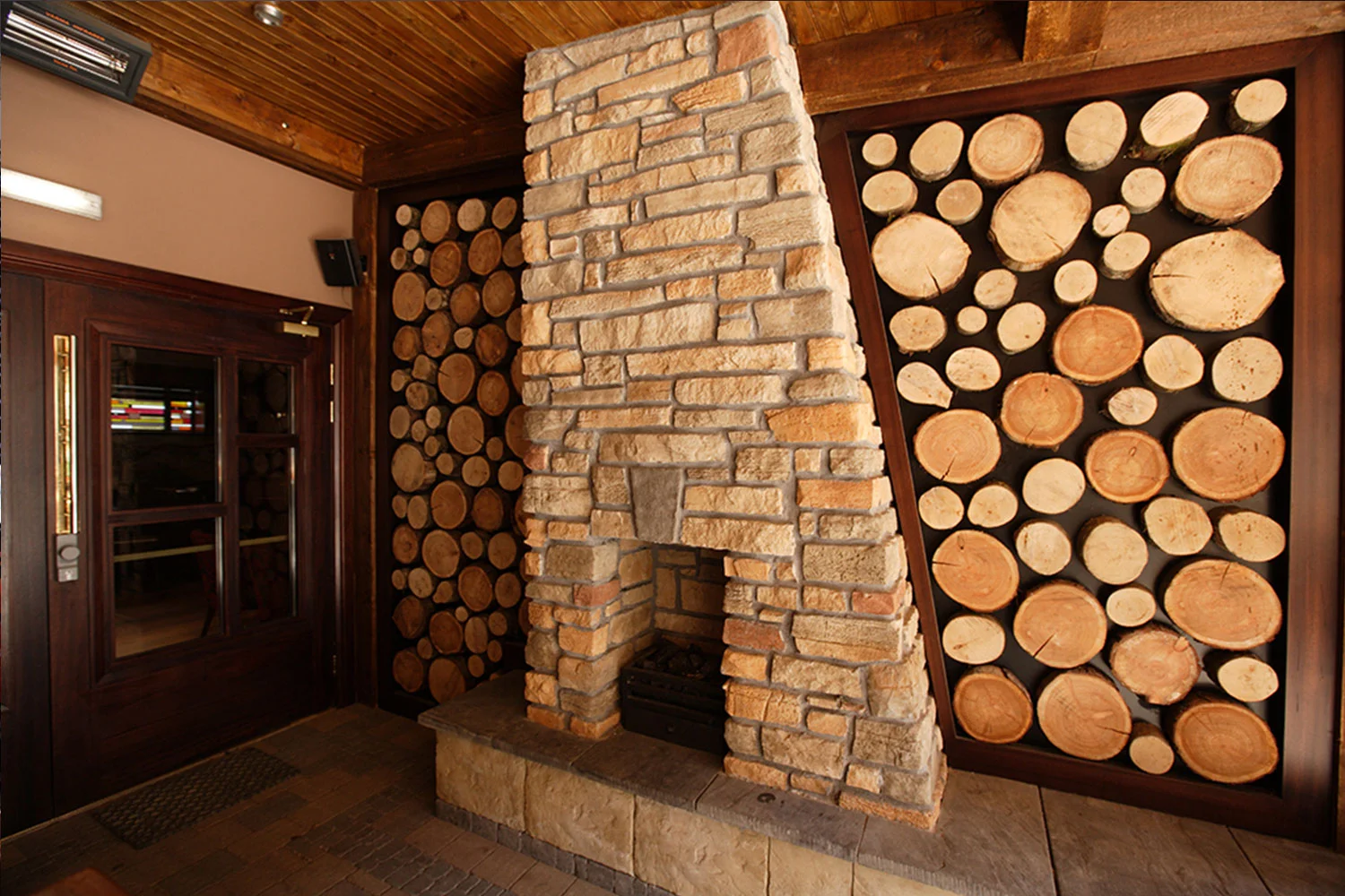 Malone's Irish Pub - wooden log walls and fireplace interior design