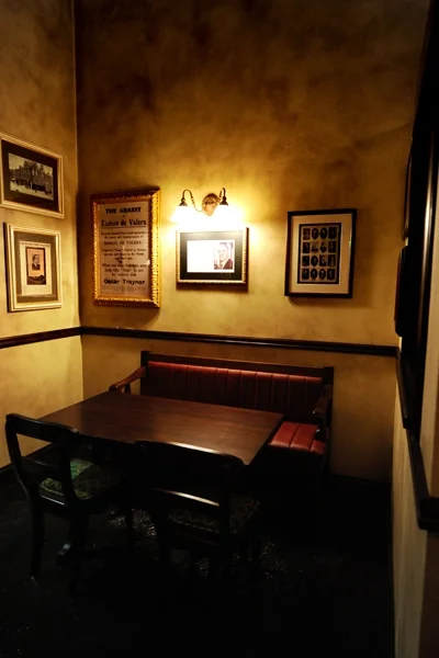 de Vere's authentic Irish pub design - interior seating low wooden table with leather upholstered seating