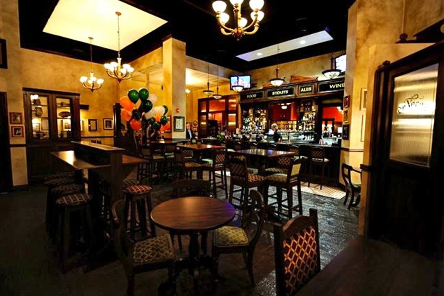 de Vere's Irish pub design interior view of wooden high tables and backed stool seating&nbsp;