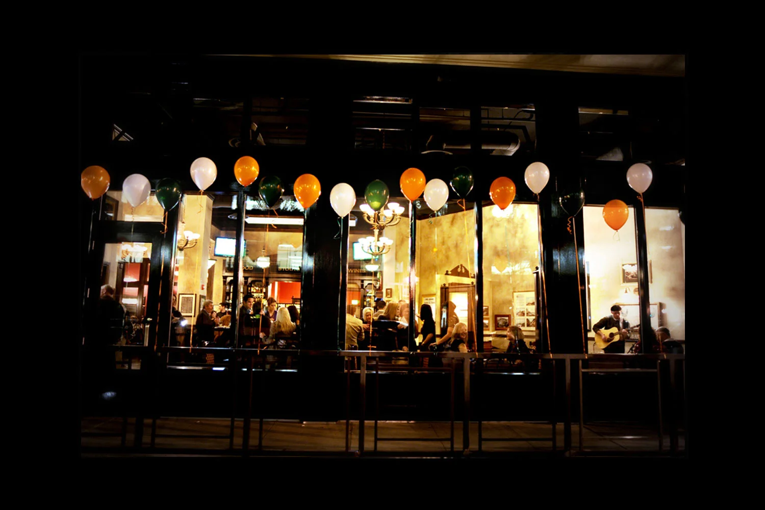 de Vere's authentic Irish pub design - exterior view with balloons in the Irish tri-colours; green, white and orange
