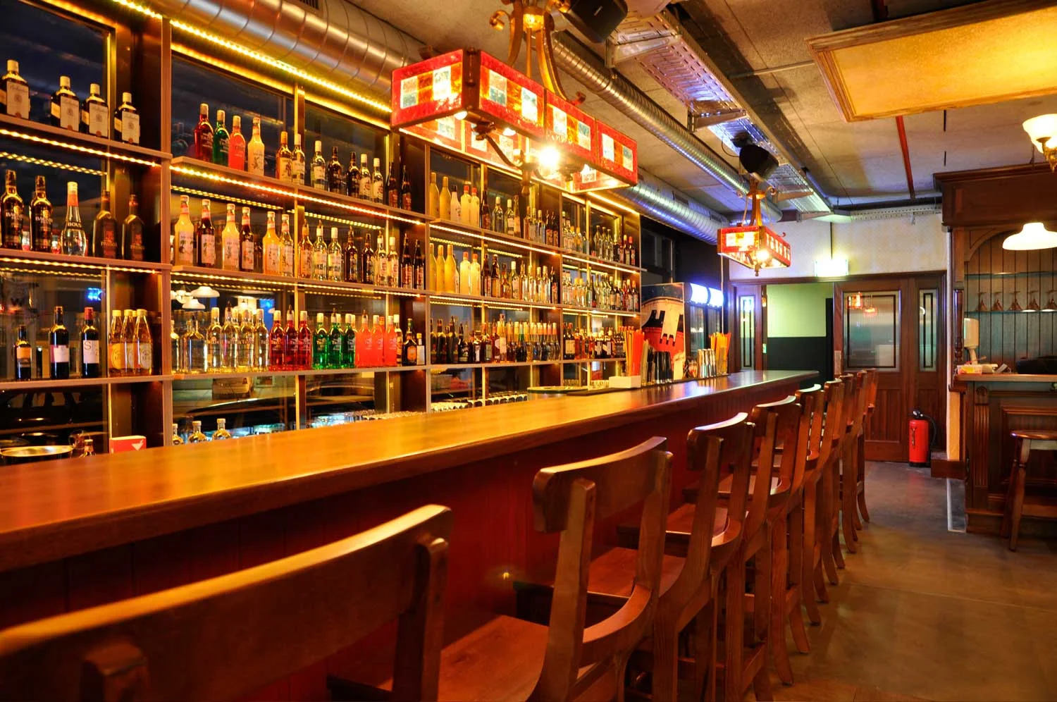 Peggy O'Neil's Irish bar design - interior view of wooden bar and stool&nbsp;
