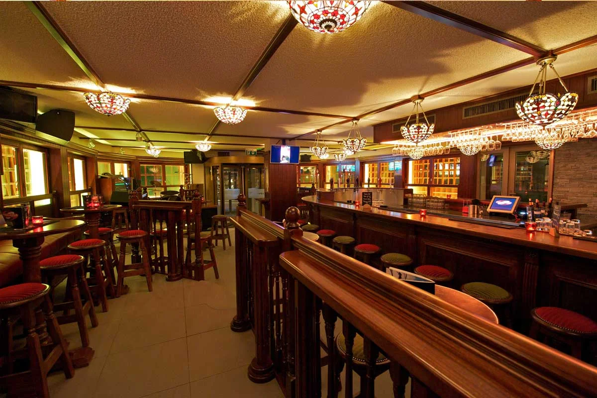 Papperla authentic Irish pub design - interior view of high wooden tables and stools&nbsp;