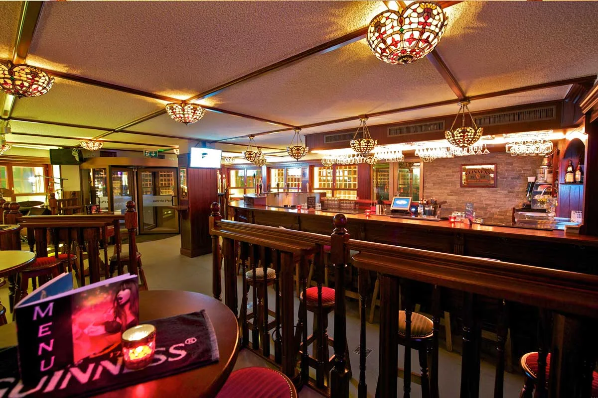 Papperla authentic Irish pub design, interior view of wooden high tables and stool seating