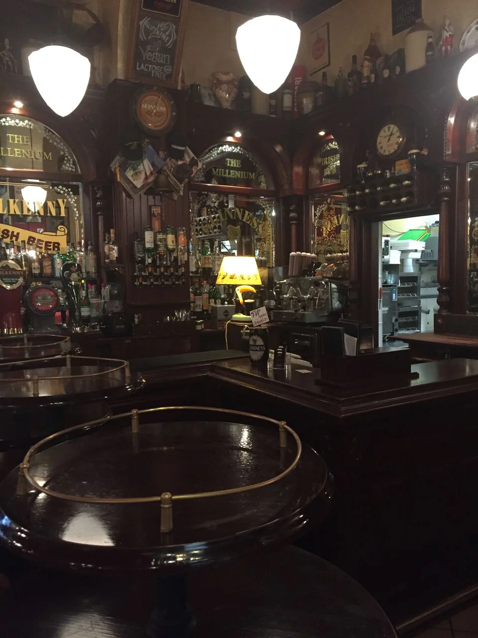 Victorian Irish Pub Design - Interior view of dark wooden furnishings and soft lighting. 