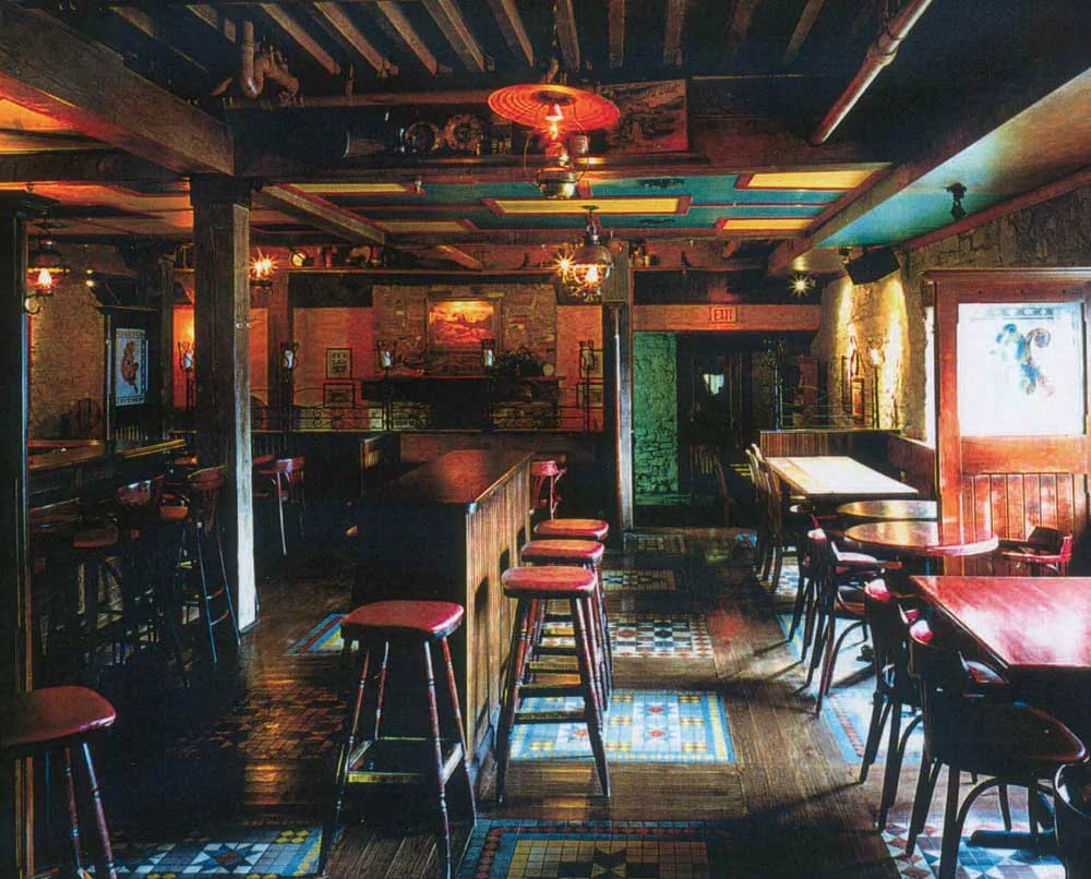 The Country Shop Irish Pub Design - interior view of high wooden counters and stools with a red wood finish.