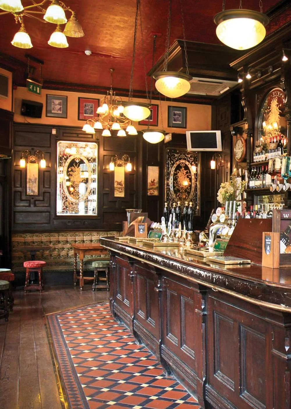 Country Cottage authentic Irish Pub Design - view of interior bar soft yellow lighting decorated with Irish trinkets.