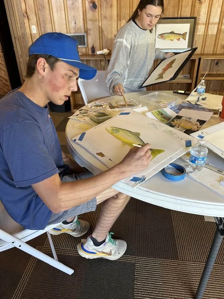 art student works on trout portrati