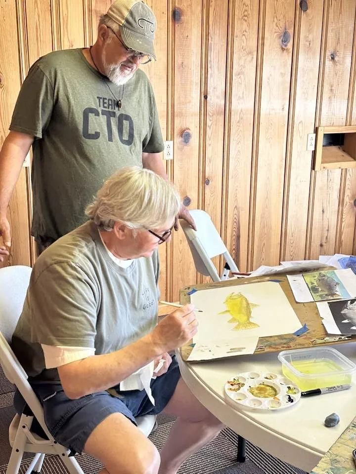 art student works on trout portrait with duane