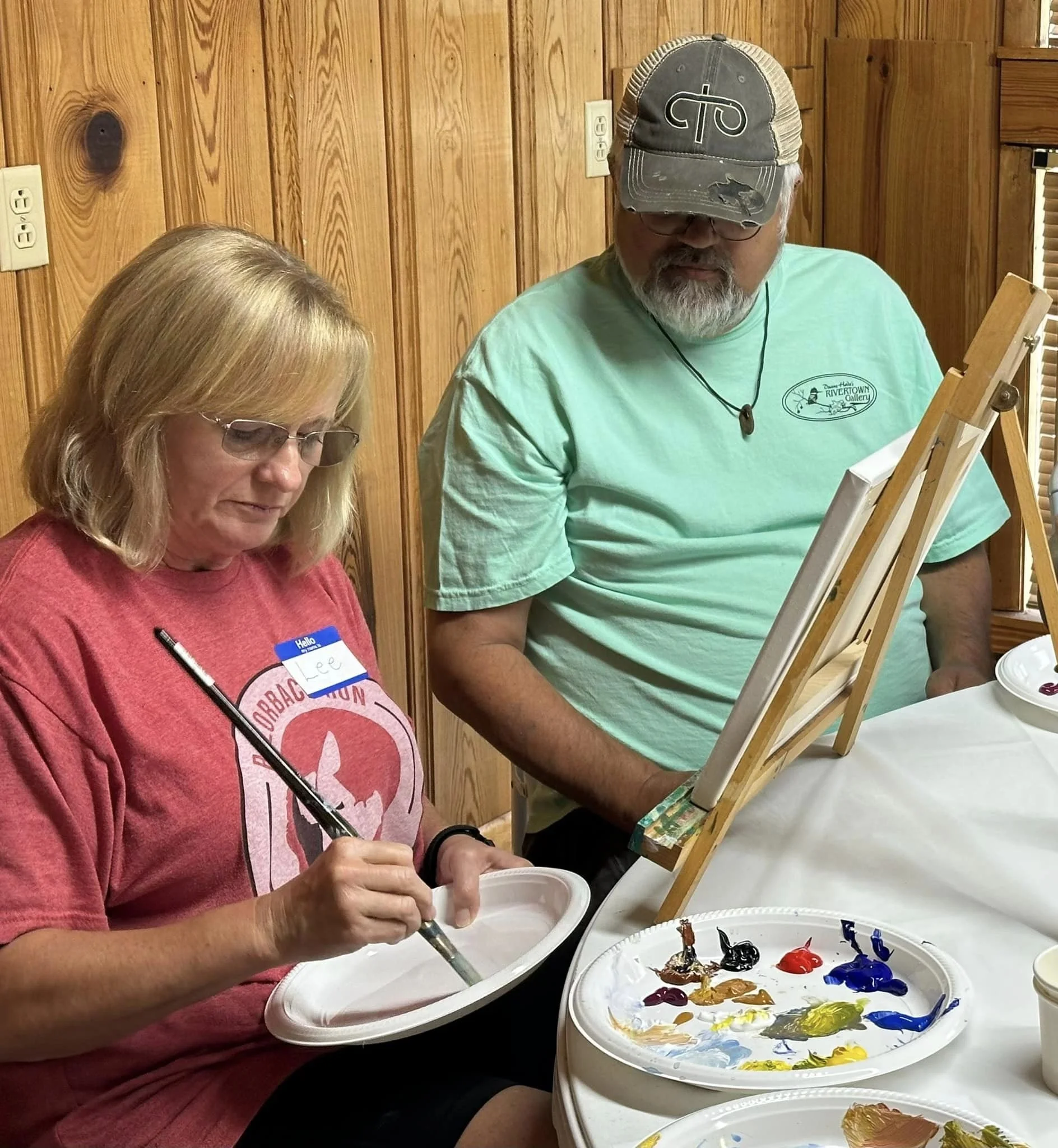 duane helps a workshop student with their acrylic painting