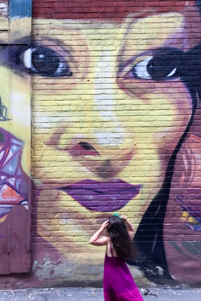 Talula admiring a downtown alley mural