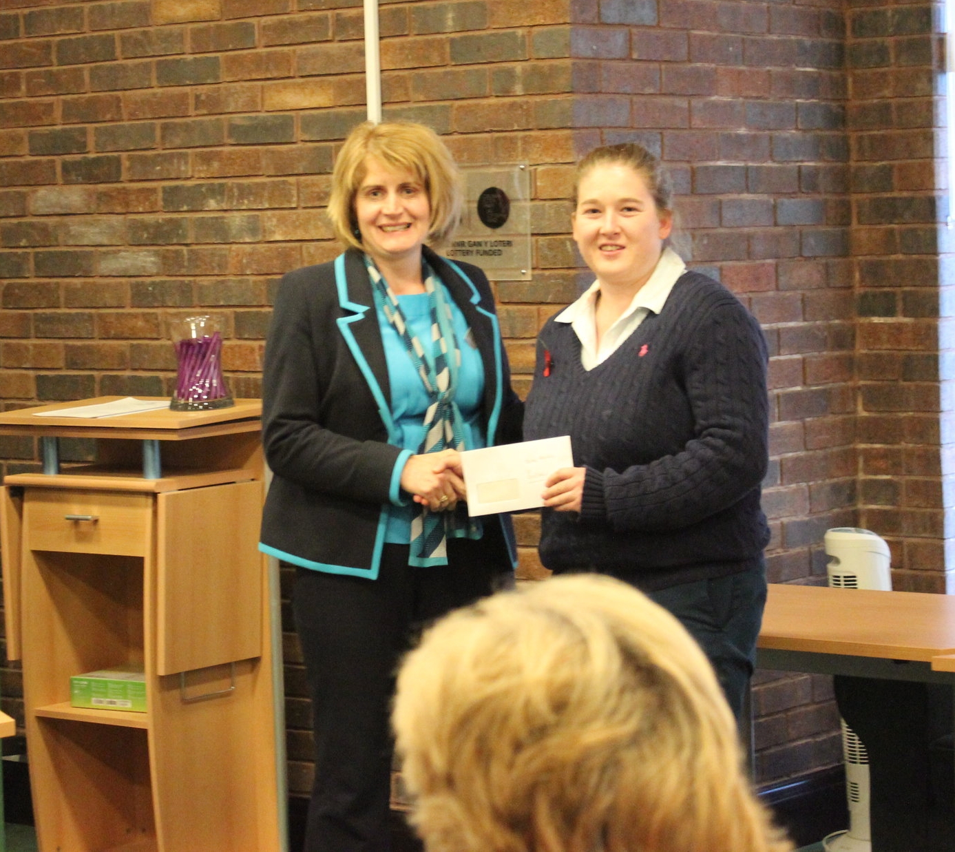 Teme Valley YFC Chairman Kim Barnett receiving the £150 Bursary from judge Jen Thomas 