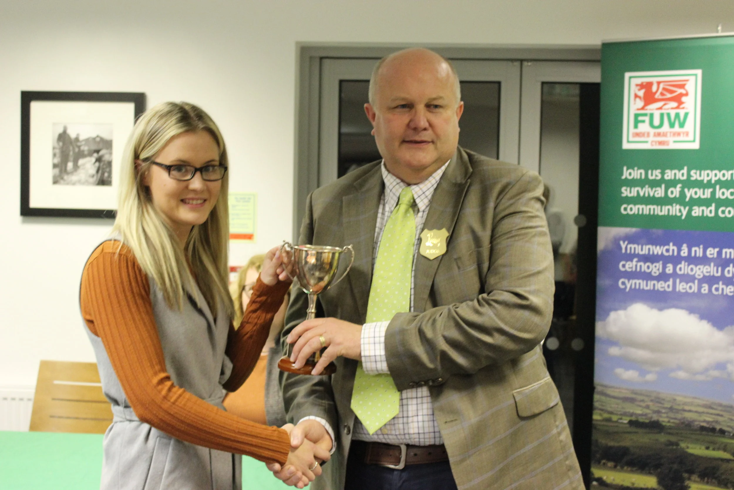 Laura Watson, Llanbadarn Fynydd YFC being presented with the Owen Duggan Memorial Cup for Best Individual by Judge Stuart Anthony.