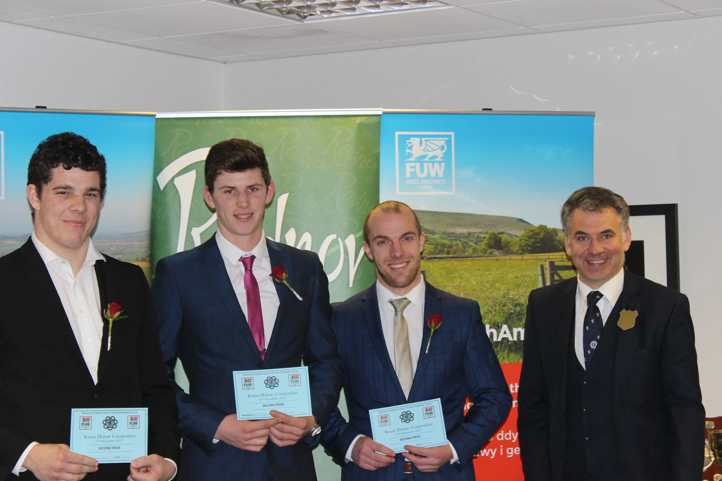 Robert Davies, Will Lewis & Mark Davies, Dolau YFC with judge Glenn Jones coming second in the Senior Debate competition.