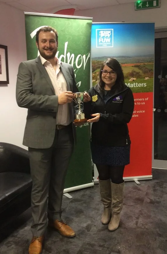 Ted Davies, Presteigne YFC being presented the Owen Duggan Memorial Trophy for best individual, by jugde Katie Davies.