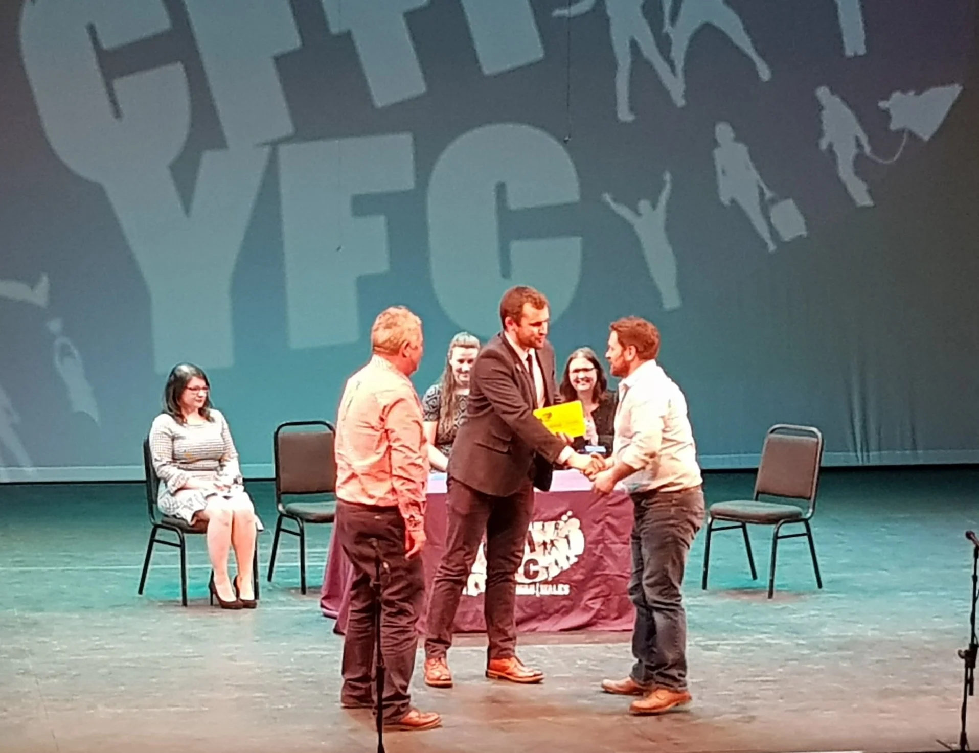 Llanbadarn Fynydd YFC’s Producers James Powell & Gwyn Price accepting third prize from Wales YFC Chairman Dafydd Jones.