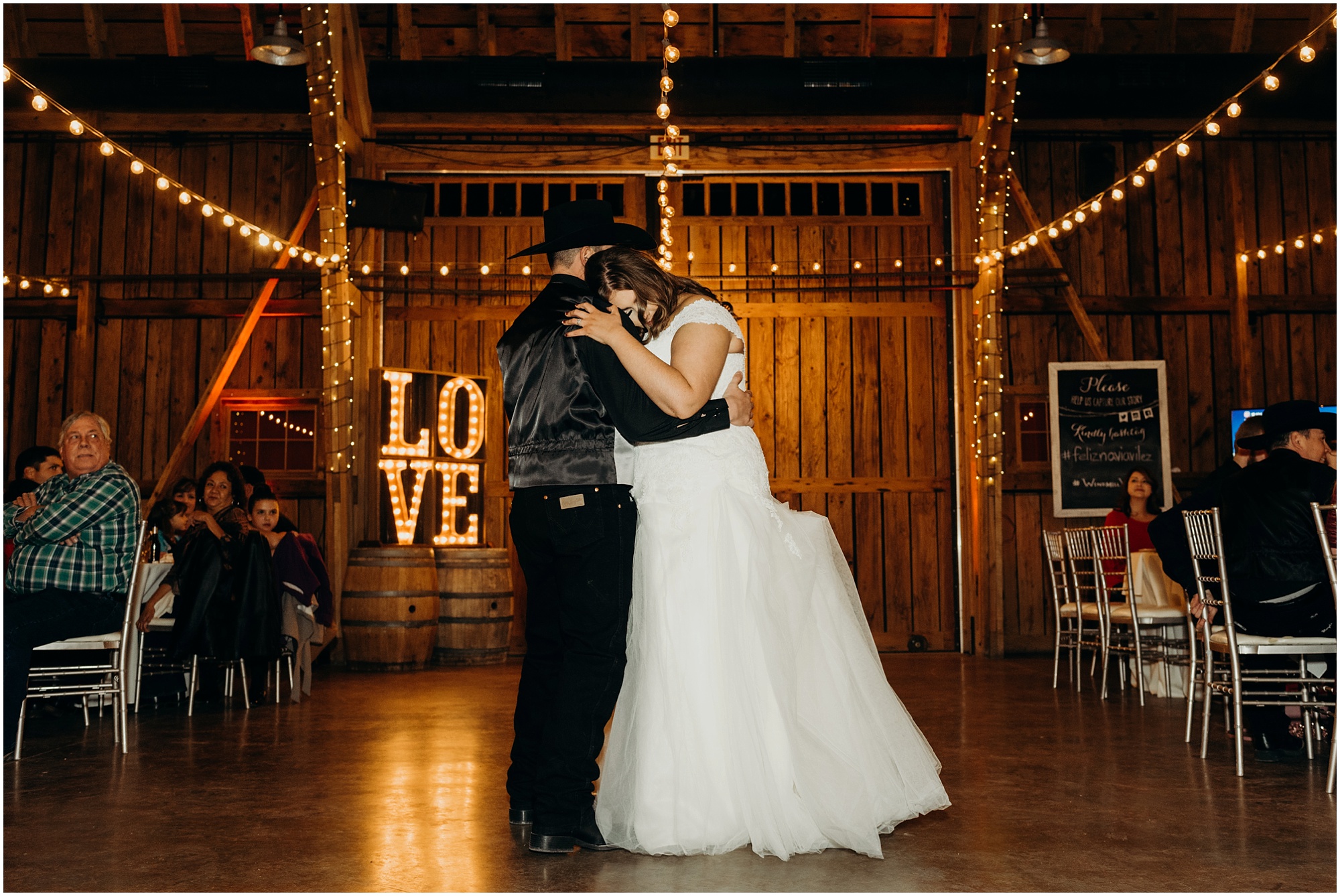 Intimate first dance photo from the couples Country Christmas Wedding Reception in a barn.