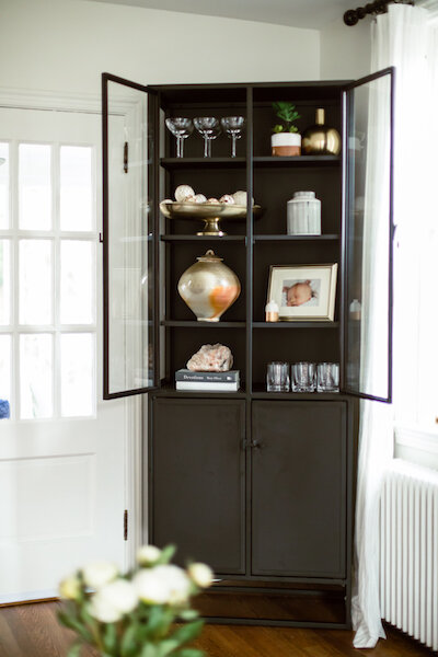 A Modern Cabinet Anchors the Corner and Provides Stylish Storage