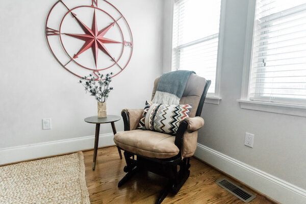 A Neutral Rocker Offers Function While Decorative Accents Add Style