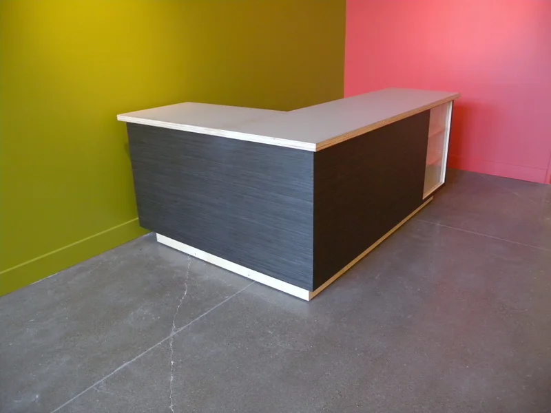 Ebony L-shaped cash wrap with birch glass display