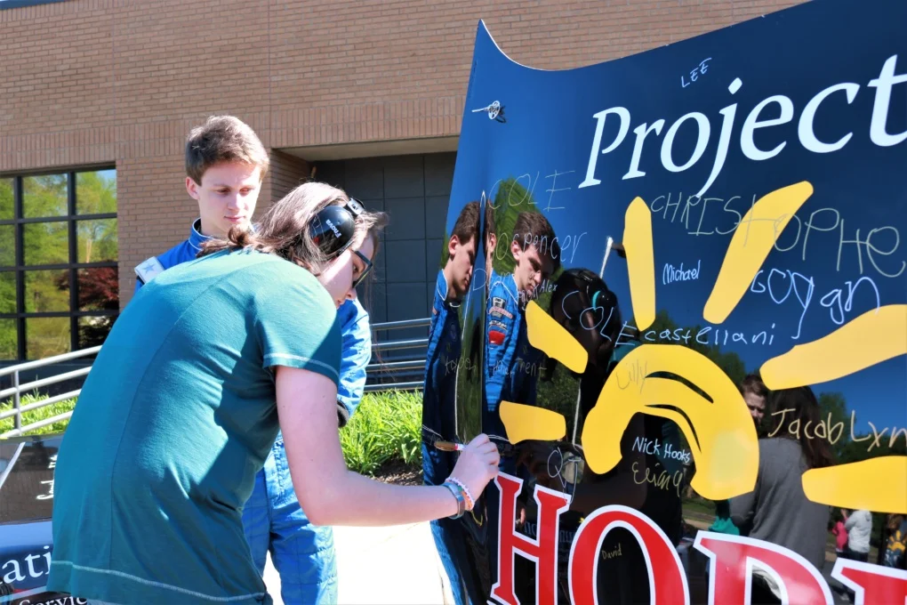 Project HOPE students and young adults signed the hood of Howard’s racecar. Photo provided.