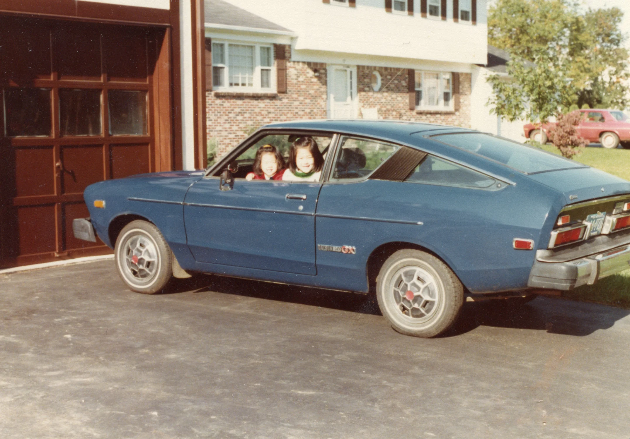 My sister and I playing in the family Datsun.