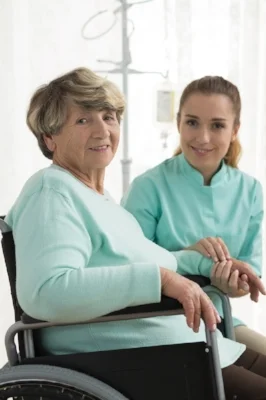 Smiling disabled woman and nurse in care home-1.jpeg