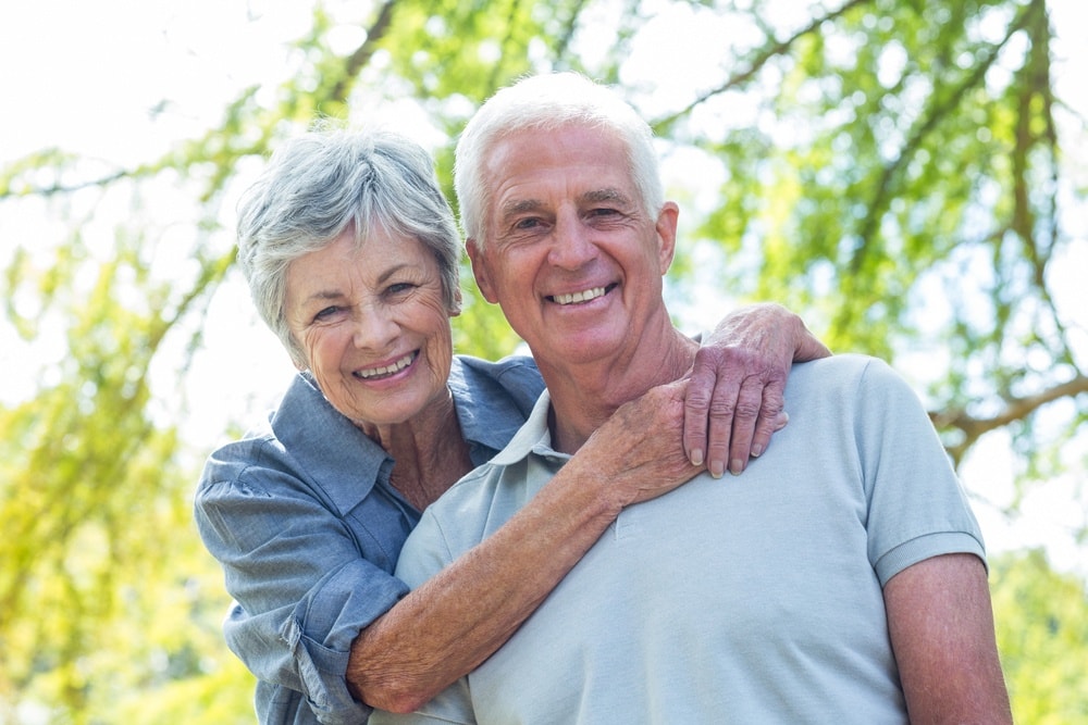 Happy old couple smiling in a park on a sunny day-1-min.jpeg