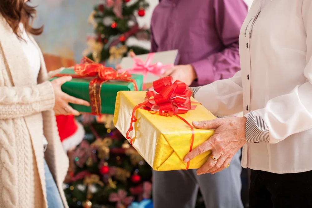 Happy family exchanging theirs Christmas gifts.jpeg