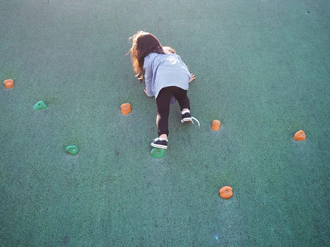 Girl climbing wall_Getty.jpg