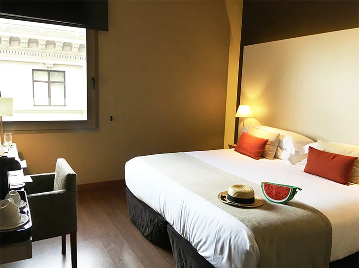 Our comfy King size bed with the view of Gothic Quarter.