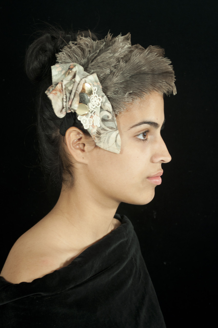 Materials: Repurposed cotton ribbon, lace table runner, buttons, feathers from a feather duster and nylon fabric.