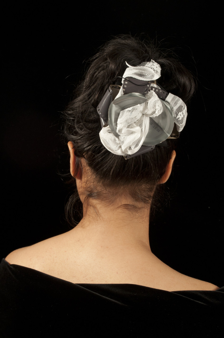 Materials: Repurposed lace trim, found photo film, aluminun can, and wire.