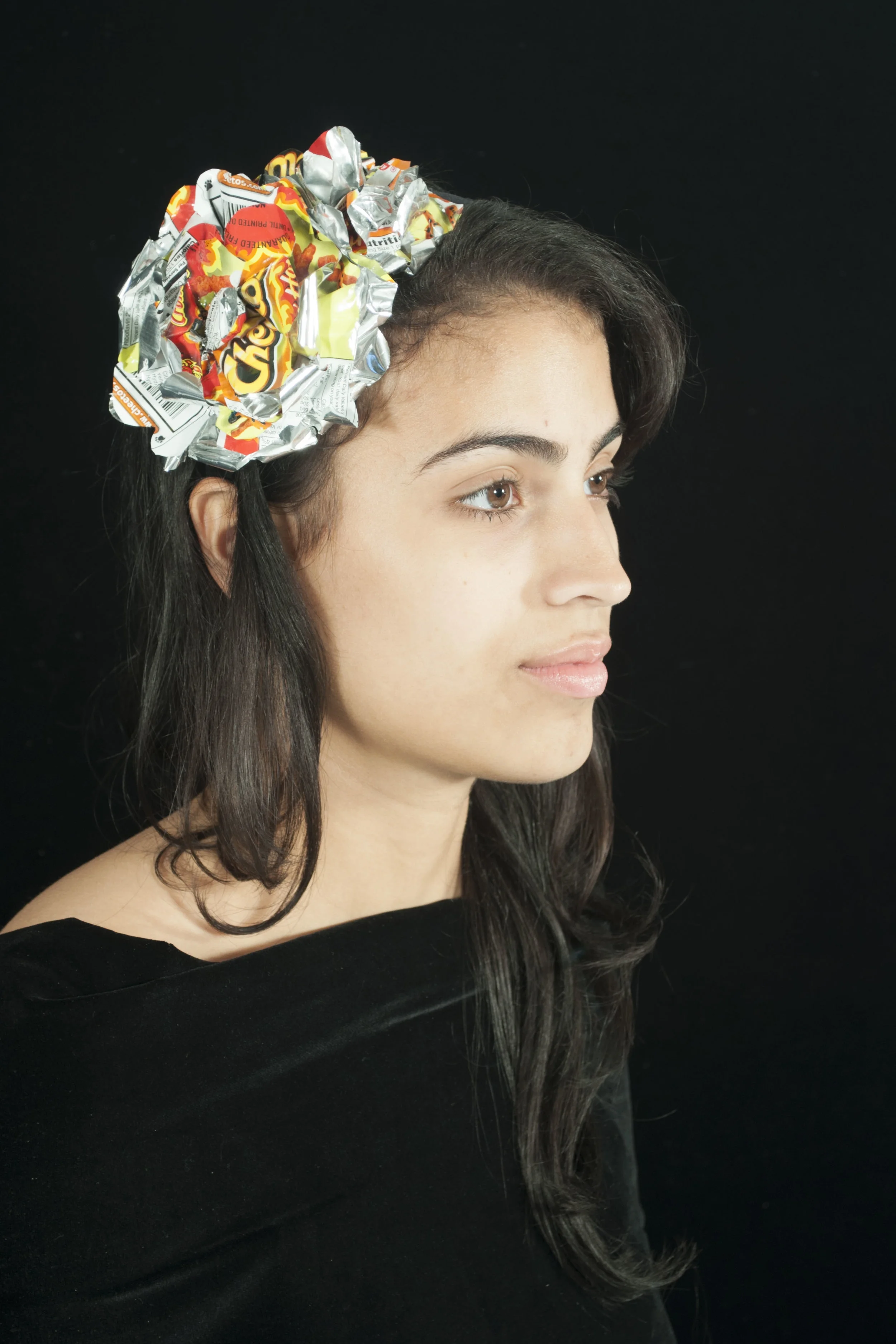  Materials: Repurposed polyester fabric with aluminum chips wrapper. 