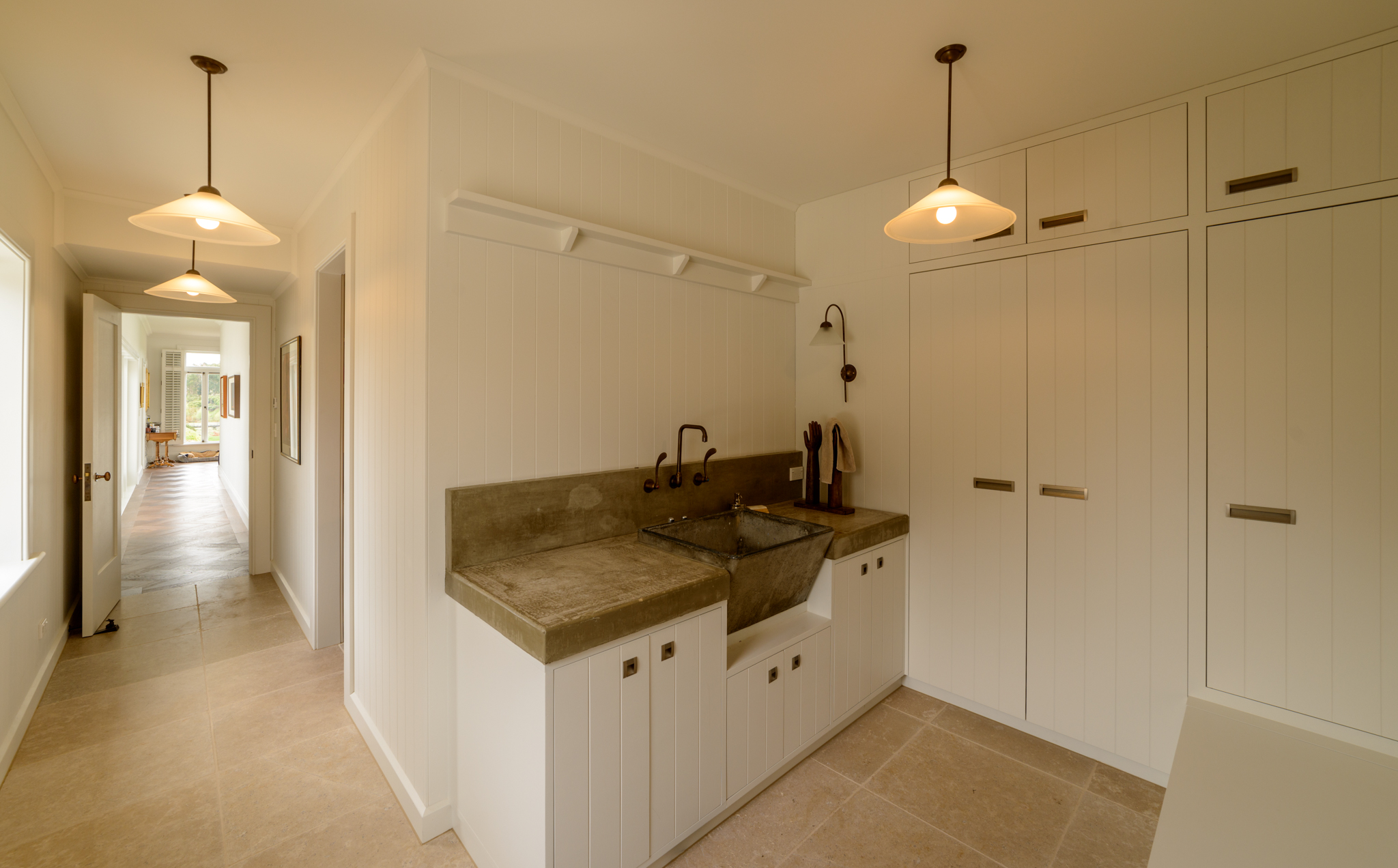 The 'mud room' features a recycled concrete tub, with recycled taps, set into a cast in-situ bench top.
