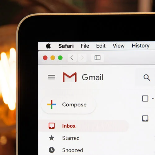 An Apple Macbook displaying a Gmail inbox.