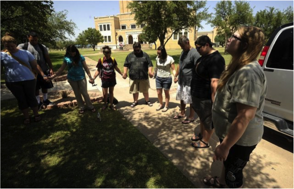 A group of McMurry University students gather in prayer as they prepare to leave for India. – Photo: Abilene Reporter-News, Thomas Metthe
