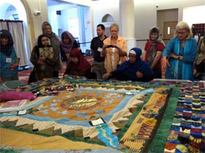 Professor Diana Eck (in blue) and seminar participants admire an interfaith quilt at the Islamic Society of Boston Cultural Center in Roxbury, MA, on one of our class site visits.Professor Diana Eck (in blue) and seminar participants admire an interfaith quilt at the Islamic Society of Boston Cultural Center in Roxbury, MA, on one of our class site visits.
