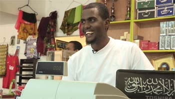 Sayid Hassan standing behind his cash register.