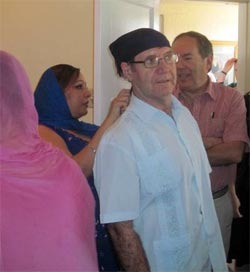 Respect means being open to the customs of individual worship sites. Here Rob Hankinson waits his turn as Paul McKenna, North American Interfaith Network trustees from Canada, has a headscarf tied on his head before joining worship at the Sikh gurdwara in Phoenix, Arizona.