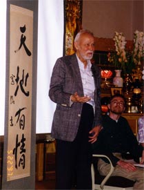 Professor Smith at the Berkeley Buddhist Monastery in 2001. The banner says "Heaven and Earth Are Sentient."