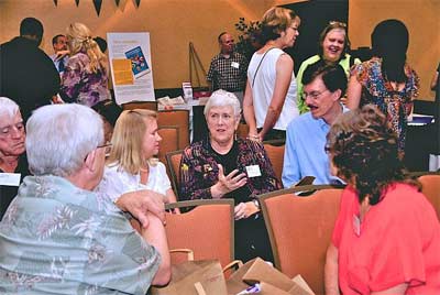 Jan Swanson, with her hand up, talks with trustees at the Phoenix 2011 Connect about bringing NAIN to Atlanta in 2012.