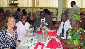Sally Mahé, l., and Joyce Ng’oma, r., URI coordinator for Malawi, Zambia, Zimbabwe, and Tanzania, meet with Ugandan URI leaders at their assembly in Kampala last August.