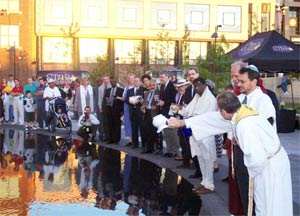 Rev. Vern Barnet, foreground, leads an interfaith celebration mixing sacred waters in Kansas City.