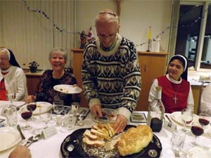 Arthur Jutan stands to bless the Challah bread