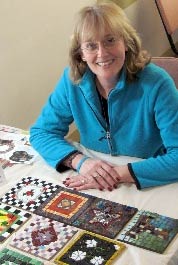 Mary Gilhuly with tiles created at the Institute.