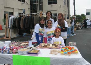 Young SARAH members in the parking lot of a local mosque selling beautiful cupcakes at a garage sale.