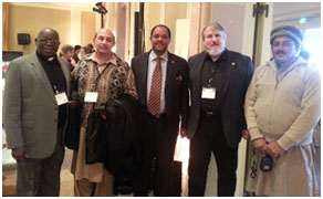 Mussie Hailu, in the tie, with Don Frew standing to his left, pose with a Catholic bishop from Uganda and two Pakistani Muslims at a URI event in San Francisco – Photo: COG